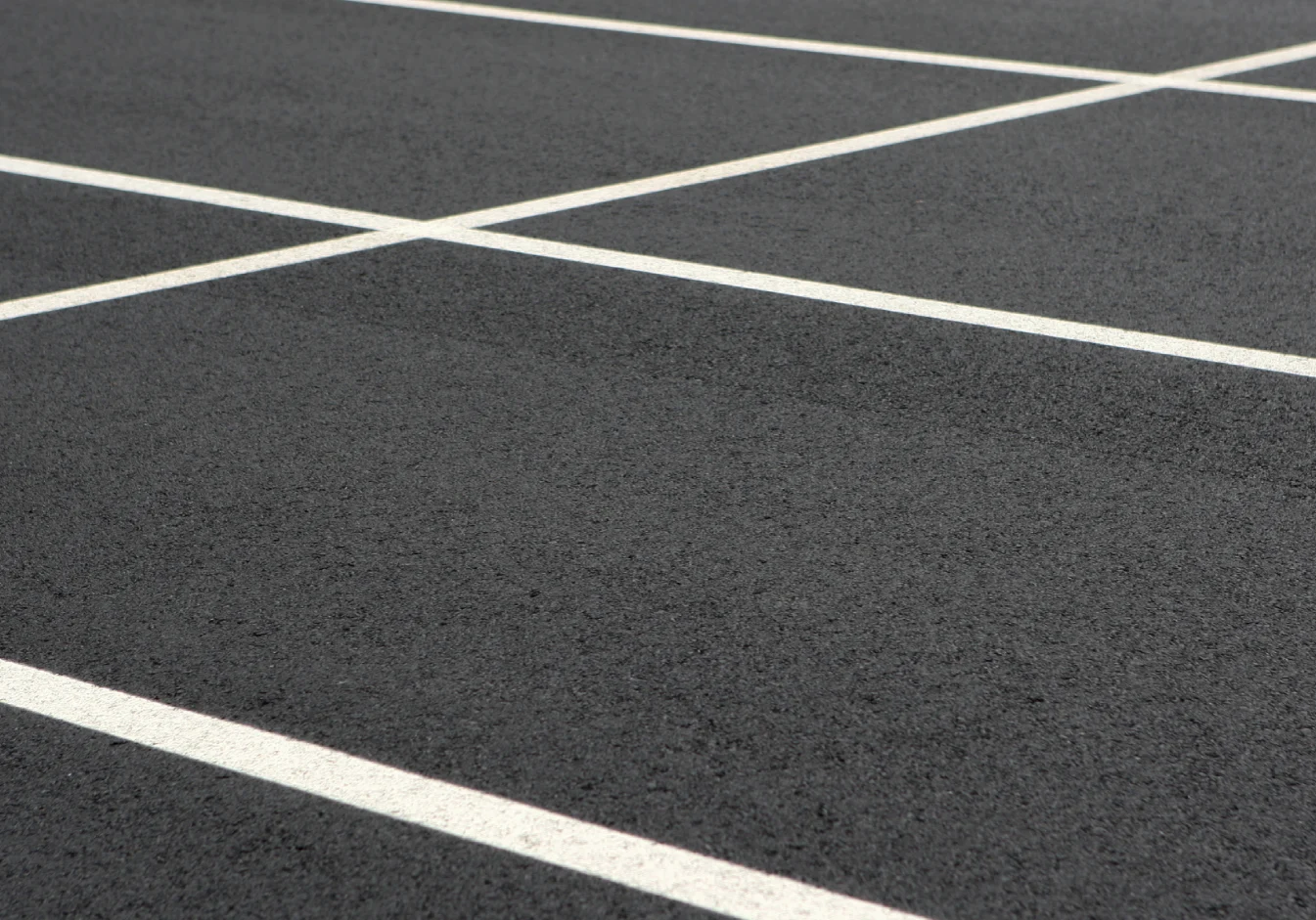 Black tarmac with crossing white stripes